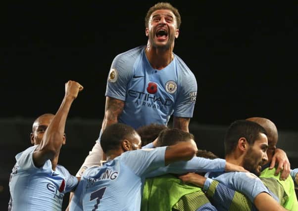 Manchester City's Kyle Walker, top, celebrates after Ilkay Gundogan scored his side's third goal in the 3-1 win over Manchester United. Picture: Dave Thompson/AP