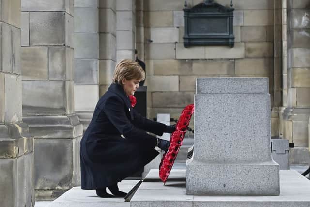 First Minister Nicola Sturgeon lays a wreath. Picture: TSPL