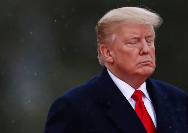 US President Donald Trump closes his eyes as he visits the American Cemetery of Suresnes, outside Paris. Picture: Getty Images