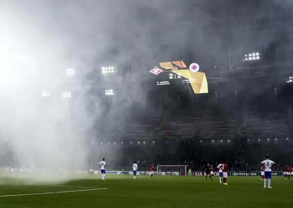 Rangers take on Spartak Moscow at the Otkritie Arena, as smoke from fireworks descends on the pitch. Picture: Getty Images