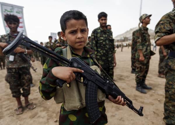 A child soldier in Huthi forces in Yemen, one of 350 million children who live in a conflict zone worldwide (Picture: Mohammed Huwais/AFP/Getty Images)