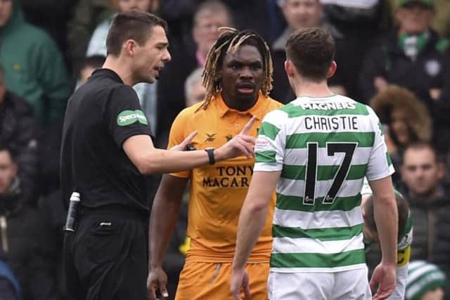 Referee Kevin Clancy attempts to cool things between Dolly Menga, centre, and Ryan Christie, right. Picture: SNS Group