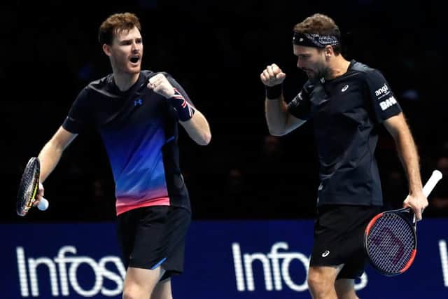 Scotlands Jamie Murray, left, and Brazilian partner Bruno Soares celebrate winning the first set. Picture: Julian Finney/Getty