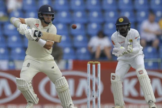 England's Sam Curran plays a shot as Sri Lanka's Niroshan Dickwella watches during the first day of the second Test in Kandy. Picture: Eranga Jayawardena/AP