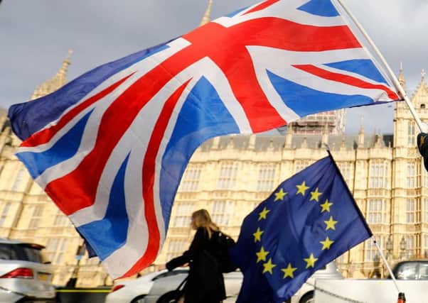 An anti-Brexit demonstrator waves a Union flag alongside a European Union flag.(Photo by Tolga AKMEN / AFP)TOLGA AKMEN/AFP/Getty Images