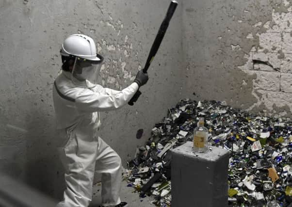 In a rage room, like this one in Singapore, people smash things up in the hope this will release tension and allow any anger to subside (Picture: Roslan Rahman/AFP/Getty)