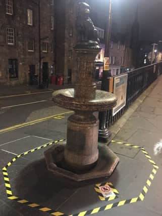 Hazard tape and signs that appeared around the statue of Greyfriars Bobby on Thursday evening - warning people not to touch the statue