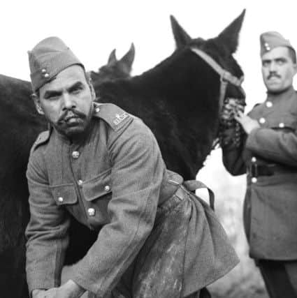 A mule handler of the Royal Indian Army Service Corps, shoeing one of the mules, during an exercise in the UK in November 1940. PIC: War Office Second World War Official Collection.