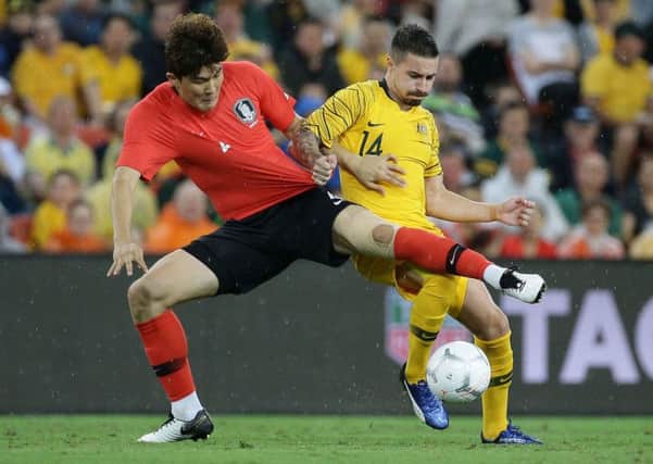 South Korea's Kim Minjae and Australia's Jamie Maclaren battle for the ball. Pic: Tertius Pickard/AFP/Getty