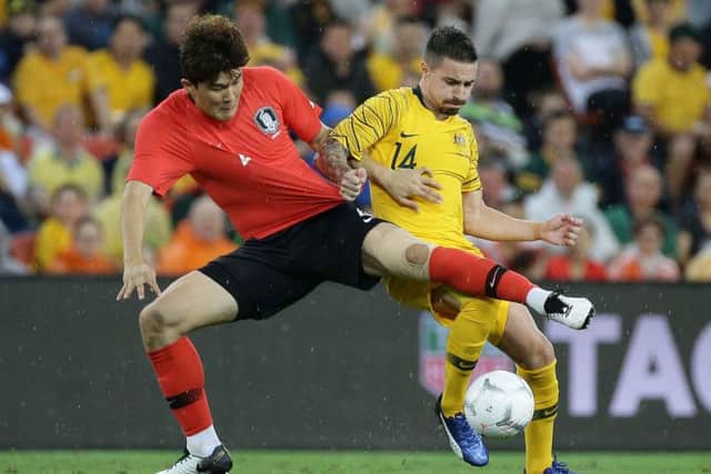 South Korea's Kim Minjae and Australia's Jamie Maclaren battle for the ball. Pic: Tertius Pickard/AFP/Getty