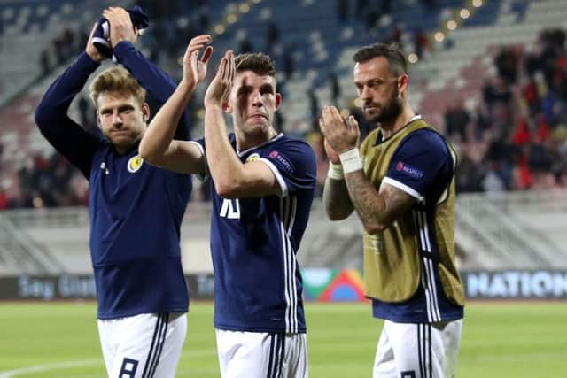 Flanked by Stuart Armstrong and Steven Fletcher, Ryan Christie applauds the travelling fans in Shkoder. Picture: Adam Davy/PA