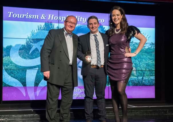 Kieran Rose, centre, receives his Thistle Award from Paul Bush, of VisitScotland, and regional final host Jennifer Reoch.