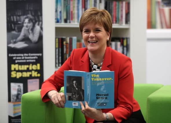 First Minister Nicola Sturgeon holds a book by Muriel Spark, during her visit to the Loanhead Centre. Picture: Andrew Milligan/PA Wire