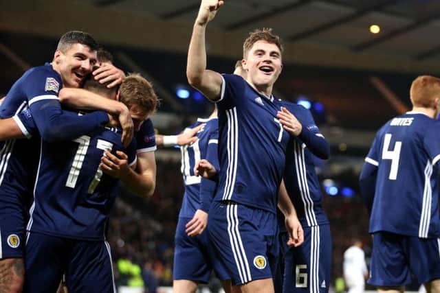 James Forrest celebrates scoring his, and Scotland's third goal. Picture: PA