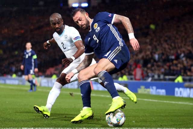 Israel's Eli Dasa, left, and Scotland's Steven Fletcher battle for the ball at Hampden. Picture: Jane Barlow/PA