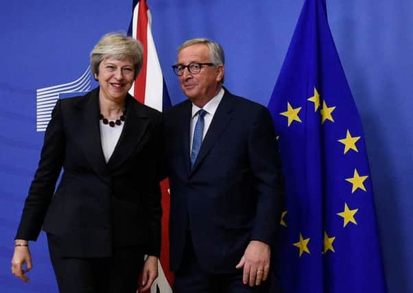 EU Commission President Jean-Claude Juncker and British Prime Minister Theresa May. JOHN THYS/AFP/Getty Images