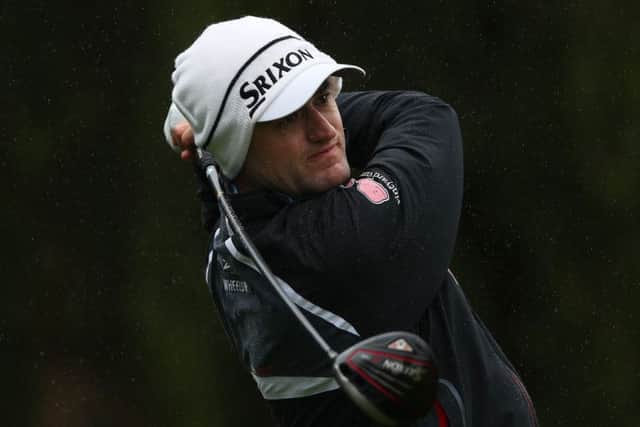 Russell Knox was well wrapped up in the brutal weather conditions for the second round of the ISPS Handa World Cup of Golf in Australia. Picture: Getty Images