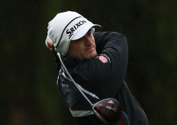 Russell Knox was well wrapped up in the brutal weather conditions for the second round of the ISPS Handa World Cup of Golf in Australia. Picture: Getty Images