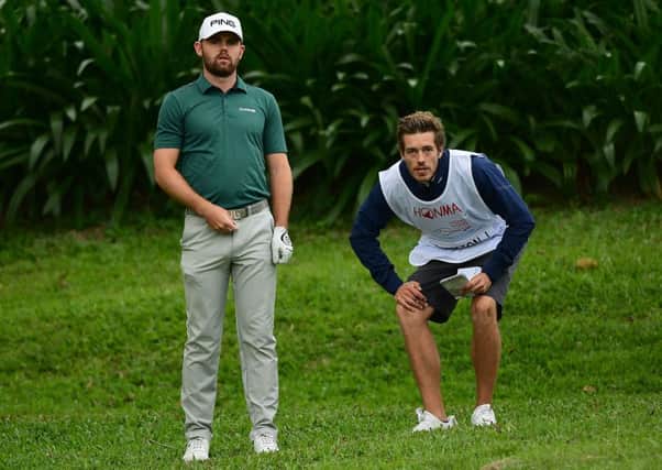 Liam Johnston, pictured working out a plan of attack with his caddie Ross Noon, safely made the cut in the Honma Hong Kong Open. Picture: Getty Images