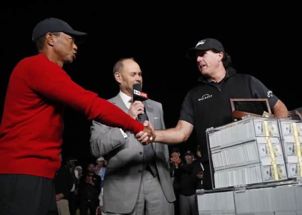 Tiger Woods, left, shakes hands after losing 'The Match' to Phil Mickelson, right, at Shadow Creek in Las Vegas. Picture: AP