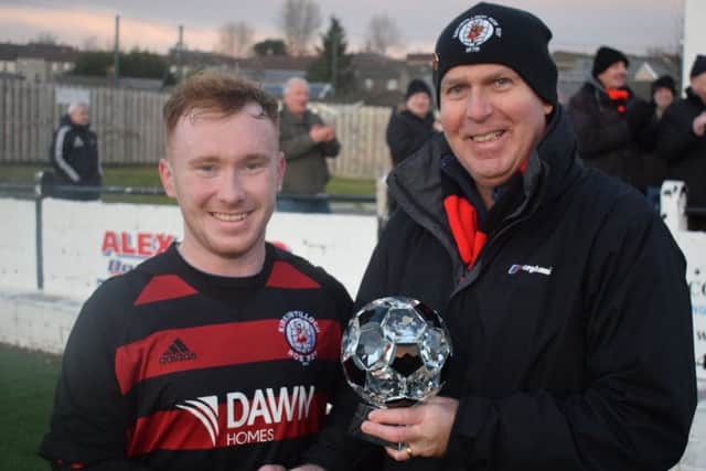 Rob Roy match winner Lee Gallacher receives the Supporters Man of the Match trophy, donated by Roddy the Dog Walker, from sponsor John Lang.