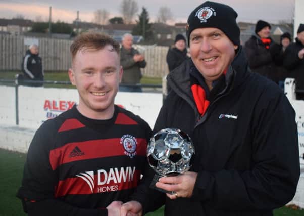 Rob Roy match winner Lee Gallacher receives the Supporters Man of the Match trophy, donated by Roddy the Dog Walker, from sponsor John Lang.