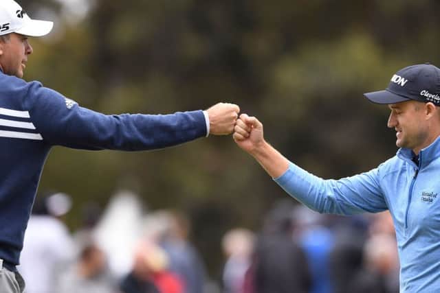 Martin  Laird and Russell Knox celebrate making a birdie during the third round of the ISPS Handa World Cup of Golf in Melbourne. Picture: Getty Images