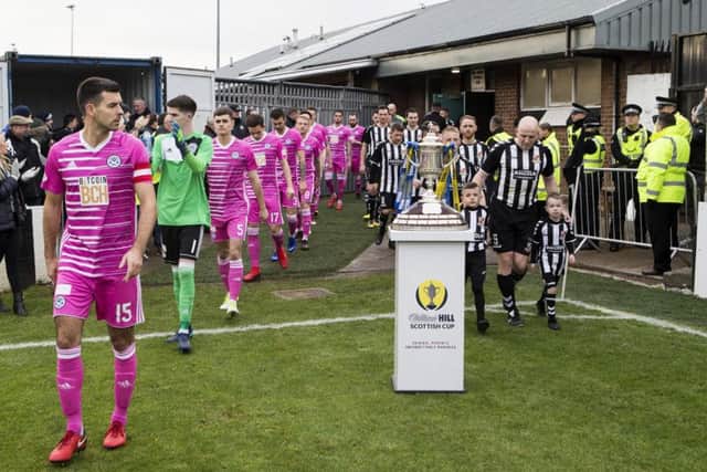 Ayr and Beith walk out in front of the Scottish Cup. Pic: SNS