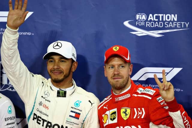 Pole position qualifier Lewis Hamilton celebrates with third place Sebastian Vettel. Pic: Charles Coates/Getty Images