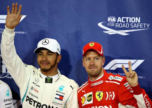 Pole position qualifier Lewis Hamilton celebrates with third place Sebastian Vettel. Pic: Charles Coates/Getty Images