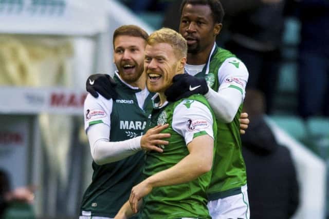 Martin Boyle, left, Daryl Horgan and Efe Ambrose celebrate Hibs' early opening goal against Dundee. Picture: Sammy Turner/SNS