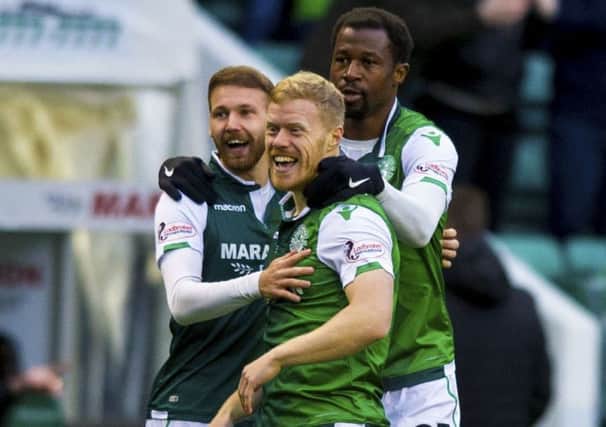 Martin Boyle, left, Daryl Horgan and Efe Ambrose celebrate Hibs' early opening goal against Dundee. Picture: Sammy Turner/SNS