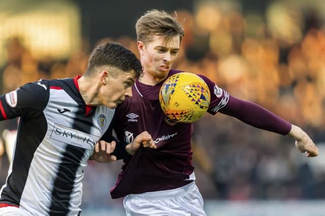 Hearts forward Craig Wighton, right, tussles with St Mirren's Jack Baird during the Tynecastle side's defeat in Paisley. Picture: SNS