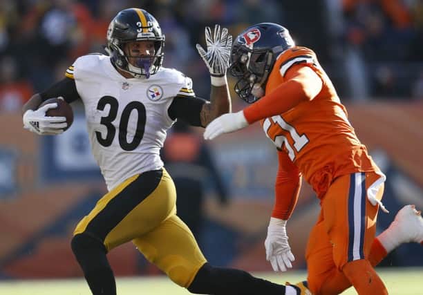 Pittsburgh Steelers running back James Conner tries to elude Denver's Todd Davis. Picture: AP