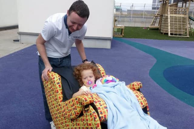 Sophie Fuller,4, recovering in hospital in July 2018 after her stroke, on the hospital rooftop with dad Edwin,32. Picture: SWNS
