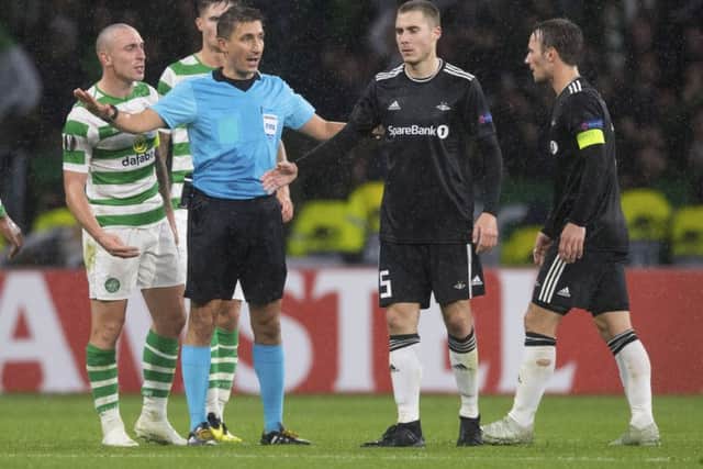 Scott Brown and Rosenborg's Mike Jensen (right) clash at the end of the last match between the sides. Picture: SNS
