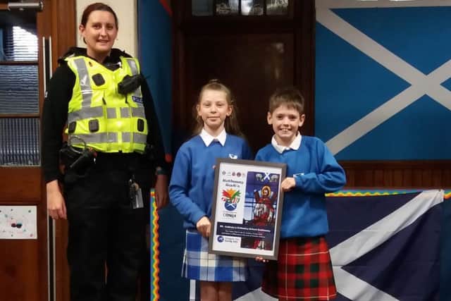 St Andrew's Primary School pupils  Melodi and Regan receiving  the school's St Andrews Conga 2018 certificate.