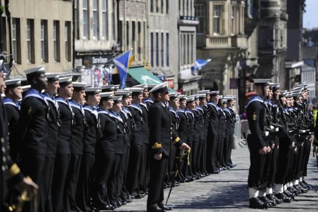 The crew of the previous HMS Edinburgh parade along the Royal Mile before the ship is decommissioned in 2013.