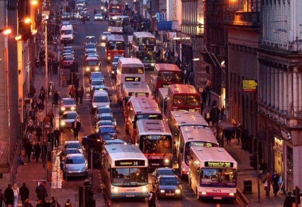 Buses are far more efficient than cars, but the latter are still Scotland's most popular form of transport (Picture: Robert Perry)
