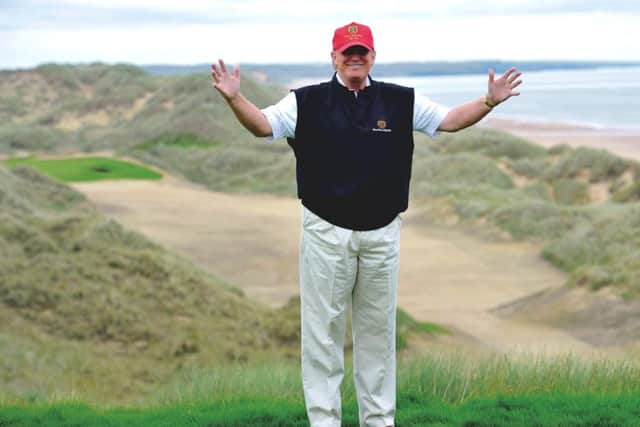 Donald Trump poses at the 18th tee of his Trump International Golf Links course in Aberdeenshire