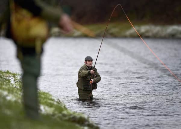 An angler fishes on the opening day of the salmon season on the River Spey  (Photo by Jeff J Mitchell/Getty Images)