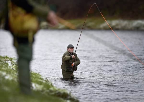 An angler fishes on the opening day of the salmon season on the River Spey (Photo by Jeff J Mitchell/Getty Images)