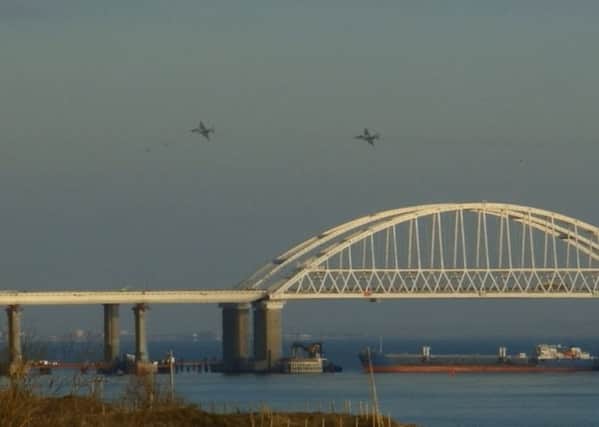 Russian aircraft fly over the Crimean Bridge as a Russian tanker blocks access to Ukraine ports via the Kerch Strait. Picture: Getty