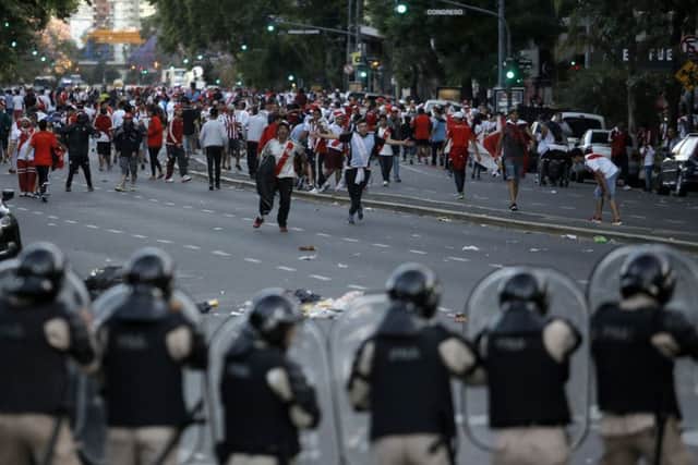 River Plate fans clash with riot police prior to the final. Pic: AP/Sebastian Pani