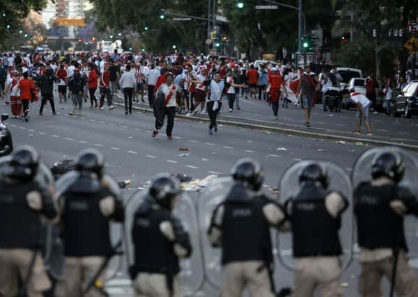 River Plate fans clash with riot police prior to the final. Pic: AP/Sebastian Pani