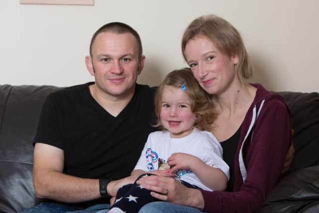 Izzy Fletcher with her parent. Picture: SWNS