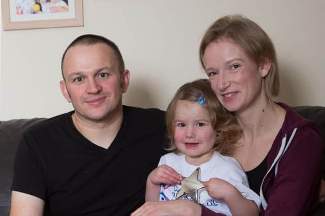 Izzy Fletcher with her parents Vicky and Dave at home in Worcester. Picture: SWNS