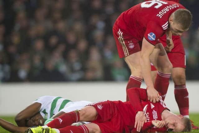 Aberdeen's Gary Mackay-Steven is assisted by team-mate Sam Cosgrove after a clash of heads with Dedryck Boyata. Picture: SNS