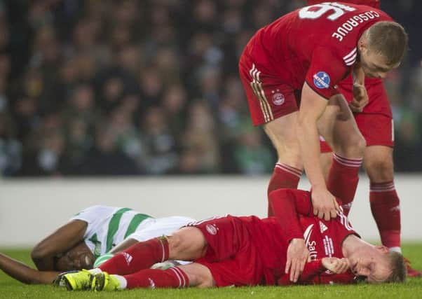 Aberdeen's Gary Mackay-Steven is assisted by team-mate Sam Cosgrove after a clash of heads with Dedryck Boyata. Picture: SNS