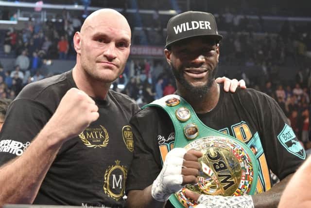 Tyson Fury, left, and Deontay Wilder share a photo afterwards. Picture: Lionel Hahn/PA